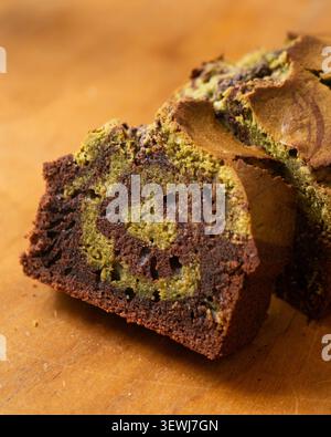 Delicious marbled chocolate and matcha tea loaf cake sliced on a wooden board Stock Photo
