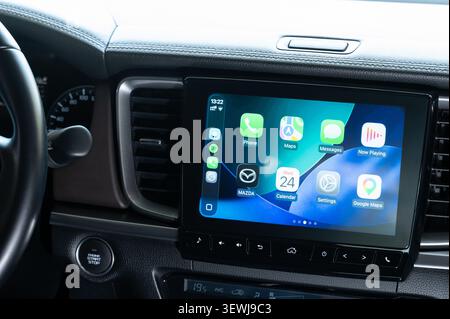 New York, USA - June 24, 2026: Using Apple carplay in car touch screen close up view vehicle dashboard background Stock Photo
