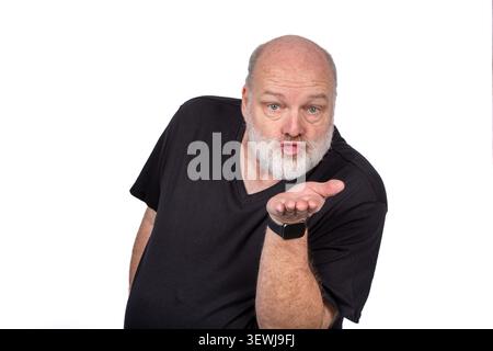 Middle Aged Bearded Man Blowing a Kiss in Black Shirt with Generic Wristwatch Isolated on White Background Stock Photo