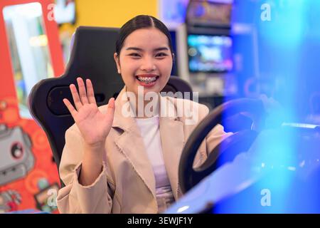 A medium horizontal portrait taken from a front-angle view showing a happy young Southeast Asian Thai businesswoman from the Isan region smiling widel Stock Photo