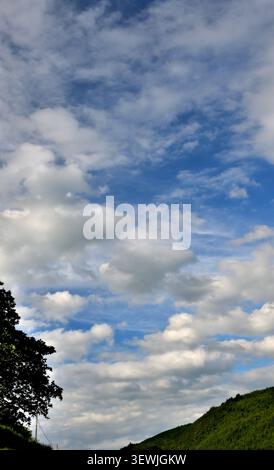 Cumulus clouds with blue sky above the Dulas Valley mid-Wales. Stock Photo