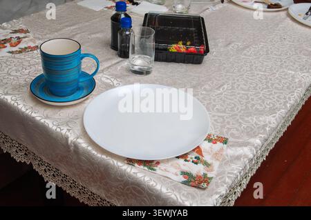 Table setting with blue mug, white plate, and festive napkin for a meal Stock Photo