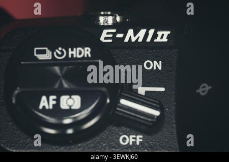 Macro photograph of the top control dial and power switch on an Olympus OM-D E-M1 Mark II mirrorless camera Stock Photo