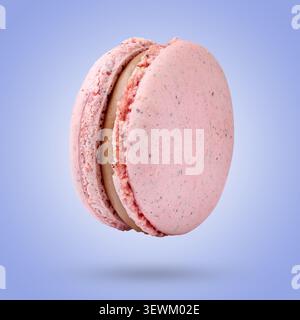 Tasty pink macaron in air against pastel blue background Stock Photo