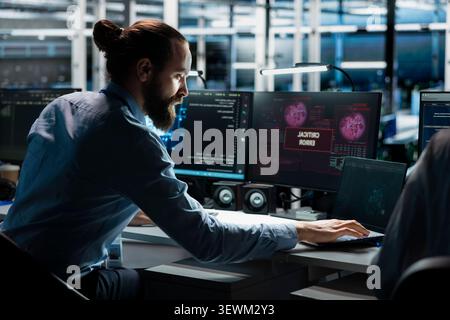 Technician works with a computer workstation in a server hub to support artificial intelligence systems. Stock Photo