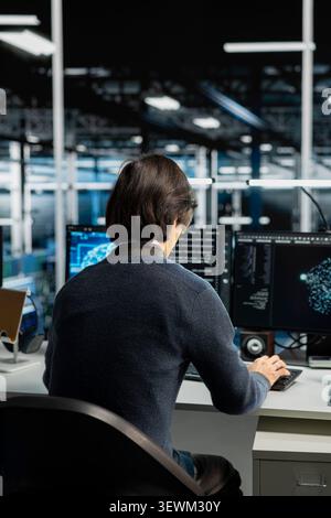 System administrator uses a digital device in a data center to support automation monitoring and reliable server workflows. Stock Photo
