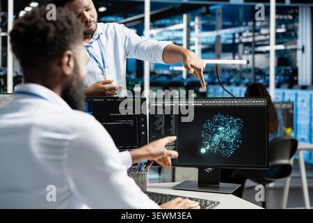 Data center manager reviews artificial intelligence systems and machine learning processes inside a data center. Stock Photo