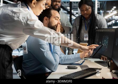 Data center colleagues collaborate on technical analysis and server infrastructure management inside a high-tech facility. Stock Photo