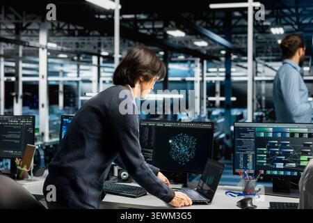 Software developer inspects server infrastructure, performs maintenance checks and reviews equipment diagnostics. Stock Photo