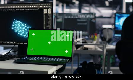Computer scientist programs on a green screen computer in a data center with generative AI assistance. Stock Photo