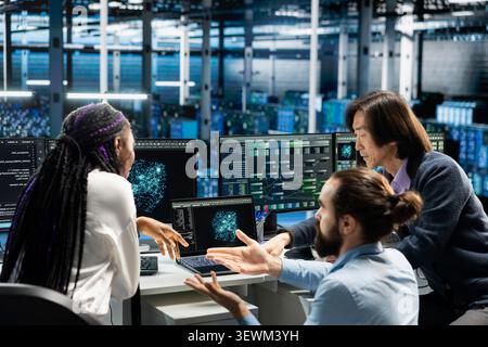 Data center team works together on diagnostics, maintenance tasks and server equipment performance checks. Stock Photo