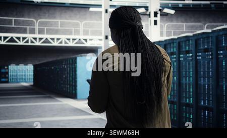 Data center technician uses tablet in a server room to monitor AI diagnostics and neural network performance. Stock Photo