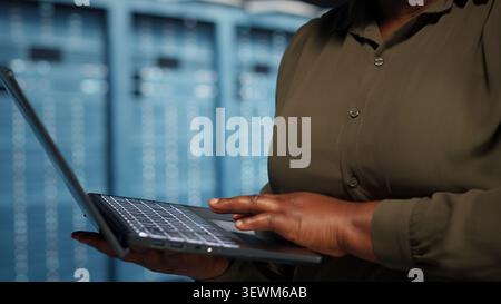 Data center manager guides programmers as they troubleshoot a critical AI system error and software glitch. Stock Photo