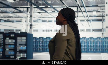 Data center manager oversees programmers reviewing AI diagnostics and machine learning systems. Stock Photo