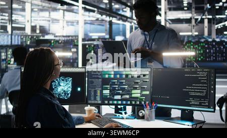 Engineer supervises node tree systems in a server farm while categorizing unstructured data. Stock Photo