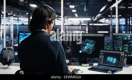 System administrator uses an AI assistant in a server room to provide technical support and user troubleshooting. Stock Photo
