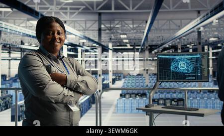 Data center colleagues use digital device deep learning tools in a server room to improve AI operations and system efficiency. Stock Photo