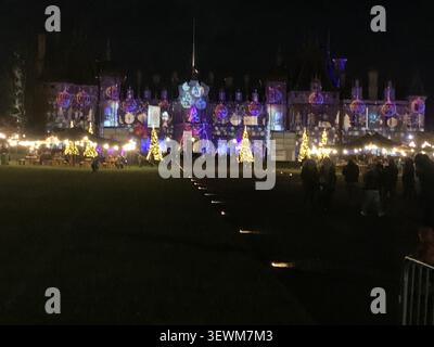 Festive lights and Christmas trees illuminate historic facade of Waddeston Manor Buckinghamshire England   its Winter celebrations Stock Photo