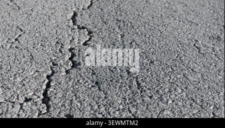 Cracked asphalt road surface Stock Photo