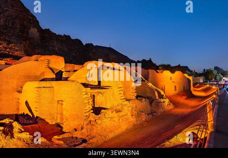Night view of the historic mudbrick ruins and traditional architecture of AlUla Old Town illuminated by warm lights in Saudi Arabia. Stock Photo