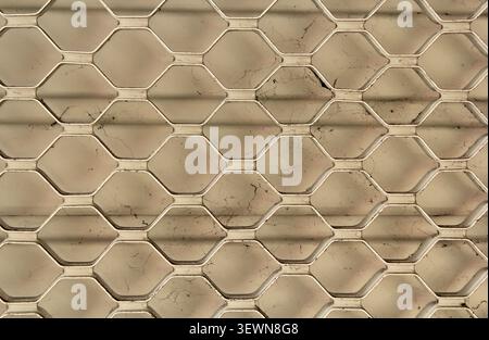 Close-up of a metal security shutter featuring a repetitive geometric hexagon mesh pattern Stock Photo