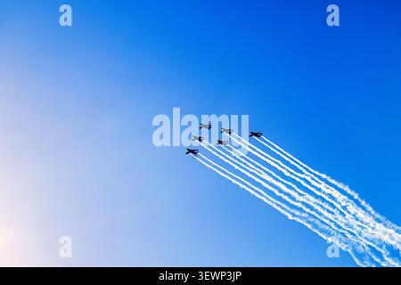 Fighter planes in formation flight with white condensation trails Stock Photo