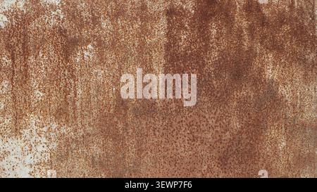 texture of old, rusty metal with severe corrosion. The surface is covered with brown spots, streaks, and a rusty oxidized coating. Stock Photo