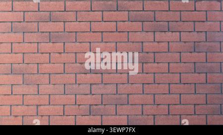 texture of a smooth wall lined with red decorative brick. The tiles have a fine-grained texture with a gradient from terracotta to dark brown. Stock Photo