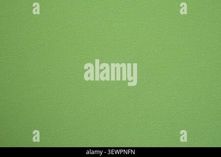 Close-up of light green textured paper with a smooth matte finish. Minimal solid color paper background with subtle texture. Stock Photo