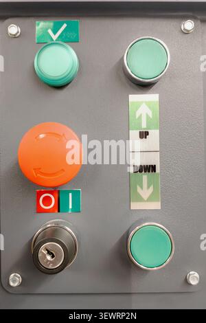 Industrial control panel featuring buttons for emergency stop reset key switch ignition and directional controls for machinery. Close up. Stock Photo