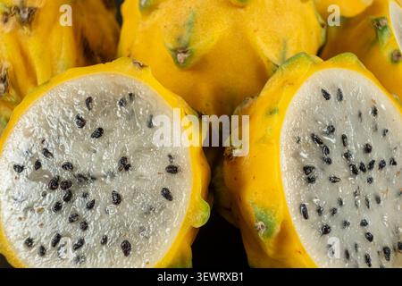 Cut ripe yellow pitahaya fruits close up view. Stock Photo