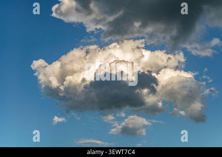 Towering Cumulus Clouds with Dramatic Light and Shadow Stock Photo