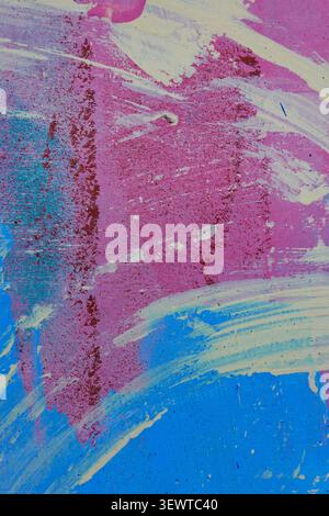 Messy white blue pink brush strokes on wall outdoors. Abstract urban background Stock Photo