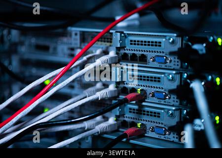 View of network cables connected to server rack ports in a data center in Los Angeles, California, United States. Stock Photo