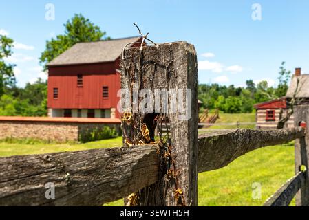 Rustic split-rail fence with the historic Daniel Boone Homestead barn in the background, Birdsboro, Pennsylvania. Stock Photo