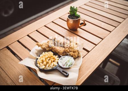 wooden dining table with various food items on it Stock Photo