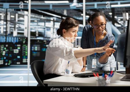 Data center manager inspects server infrastructure, performs maintenance checks and reviews equipment diagnostics. Stock Photo