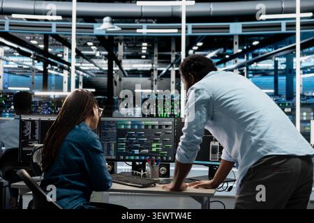 Computer scientists program data center equipment for machine learning training, upgrading AI systems with code on a PC. Stock Photo