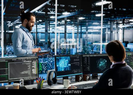Data center engineer works on a computer to monitor AI systems, neural networks and server infrastructure. Stock Photo