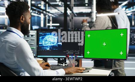 Data center administrator uses node tree software to identify equipment performance issues and data patterns. Stock Photo