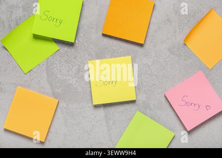 Sticky notes with word SORRY on grunge background Stock Photo