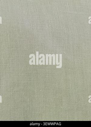 Detailed macro shot of light olive green dyed natural linen textile weave texture Stock Photo