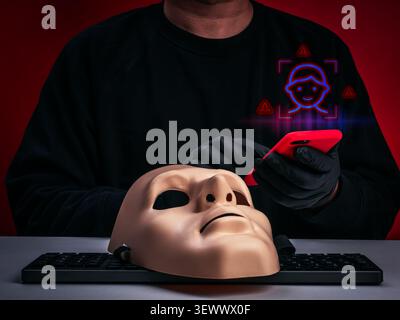 Deepfake scam and synthetic identity fraud concept featuring masked cybercriminal scammer using smartphone. Voice cloning fraud, romance scams, social Stock Photo
