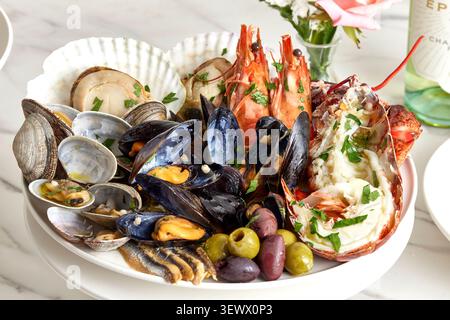 Gourmet seafood platter with fresh mussels, shrimp and clams served on a white plate, fine dining restaurant food photography Stock Photo