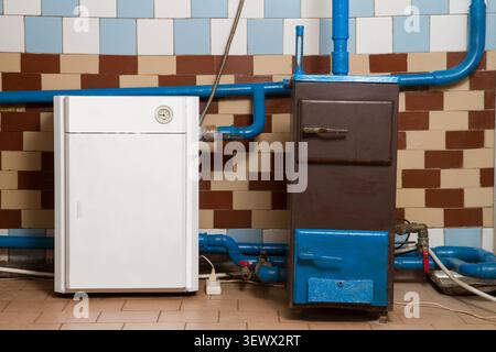 Heating system of a rural house. Gas boiler and solid fuel boiler. Heating of a private house. Stock Photo