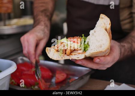 chicken doner kebab sandwich, a popular Turkish street food often served with fresh vegetables. Stock Photo