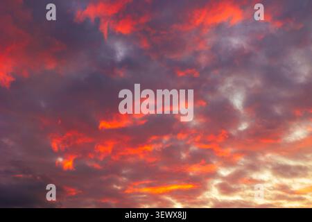 Orange sunset sky background. Dramatic partly cloudy sky view. Stock Photo