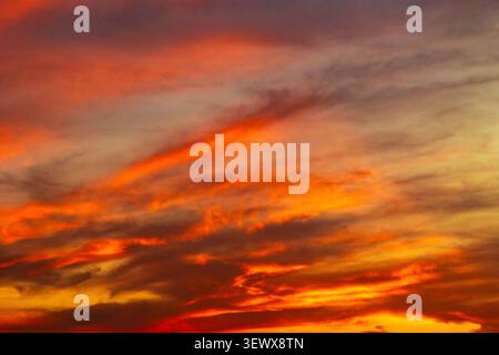 sunset background. Dramatic orange clouds in the sky at sunset Stock Photo
