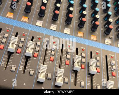 White faders and level indicators on an audio mixing console Stock Photo