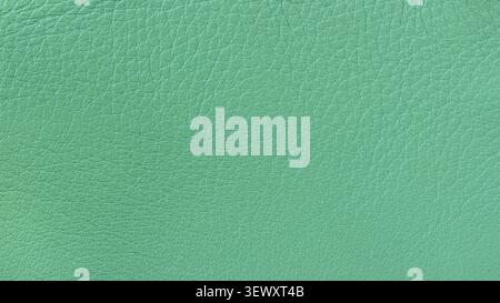Turquoise leather texture with wrinkles, grain, scratches, and coated surface for design use. Natural background texture for fashion, packaging Stock Photo